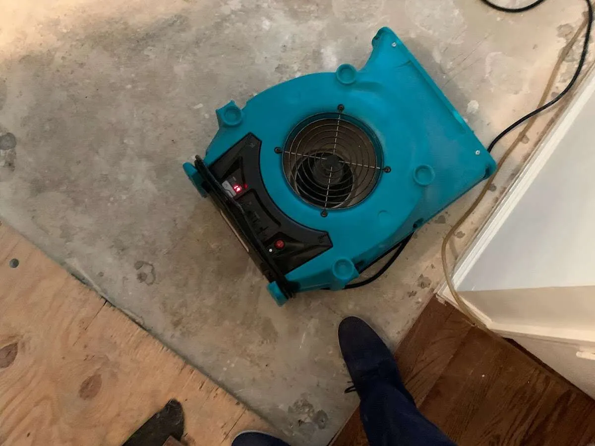 Air mover drying subfloor during Commercial Water Damage Restoration in Brooklyn Center